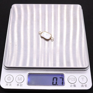 Macro view of a 0.7g rectangular freshwater pearl connector with gold plating and double rings