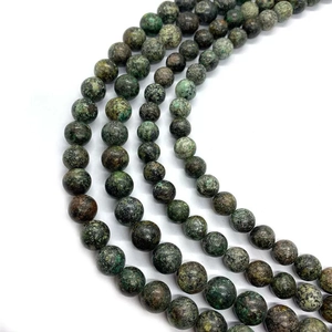 Detailed macro view of polished African turquoise stone beads with natural mottled texture