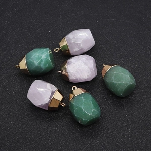 Macro view of faceted natural stone pendants with gold plated metal caps for DIY jewelry