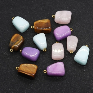 Detailed view of irregular tiger eye stone pendants with polished finish and gold bail