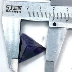 Macro shot of 18mm triangular cut purple amethyst stone measured with a digital caliper