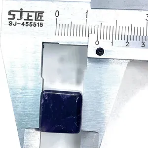 Macro shot measuring dark purple amethyst gemstone cube with a digital caliper tool