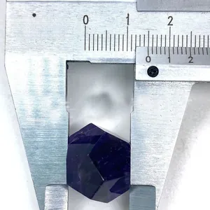 Macro view showing a 1.5cm faceted purple amethyst crystal measured with a caliper