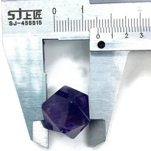 Macro shot of a faceted purple amethyst crystal sphere measuring 21mm with a caliper