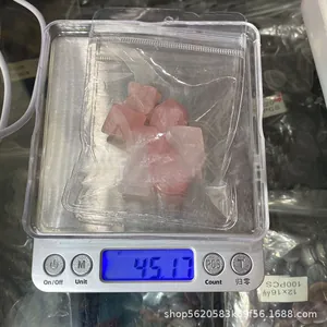 Macro shot of 7pcs pink quartz crystals in geometry shapes on a digital scale weighing 45.17g