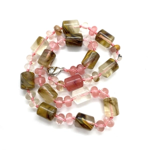 Detail of beaded necklace with brown turquoise cylinders, pink beads and silver lobster clasp