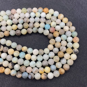 Macro detail of mixed color natural stone beads with smooth polished texture and cloud-like veins