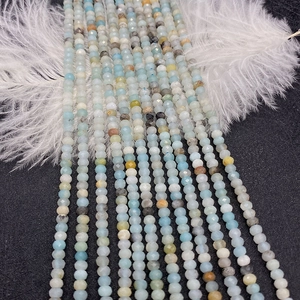 Close-up of faceted natural Amazonite gemstone beads with fine texture and pale blue hues