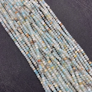 Macro shot of faceted light blue Amazonite stone beads with a diameter of 2-3mm