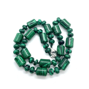 Malachite stone necklace with cylindrical beads and silver lobster clasp on white background