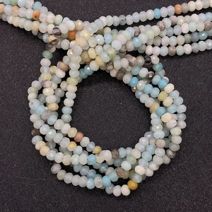 Macro shot of natural faceted Amazonite beads in assorted light blue and earthy tones