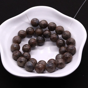 Natural coffee labradorite round loose beads for DIY jewelry making on white ceramic dish