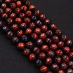 Close-up of red tiger eye natural stone beads with silk luster for DIY jewelry