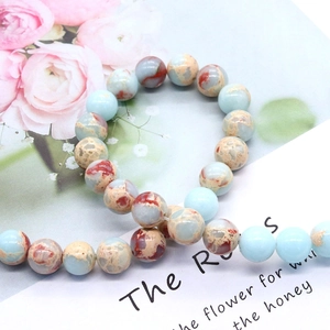 Round natural stone beads in light blue and mottled reddish-brown for DIY jewelry making