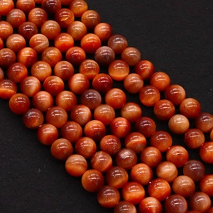 Close-up of natural red tiger eye beads with chatoyant effect for jewelry making