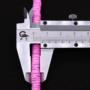 Macro detail of 6mm pink natural shell disc beads measured by caliper for DIY jewelry
