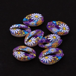 Macro shot of seven colorful floral printed natural seashells for DIY jewelry making