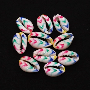 Macro shot of colorful painted cowrie shells with zigzag patterns for DIY jewelry making