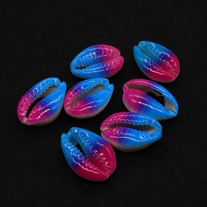 Macro shot of natural shell beads with vibrant pink and blue gradient for DIY jewelry