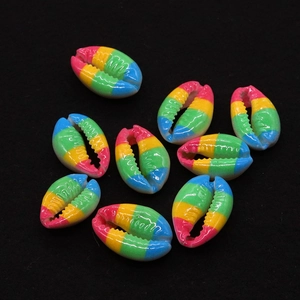 Close-up of rainbow striped conch shell beads for DIY jewelry making on black background