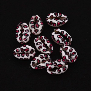 Macro detail of natural cowrie shells with leopard print spots for DIY jewelry making