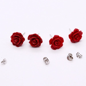 Classic 10mm red rose coral stud earrings with silver metal backs on white background