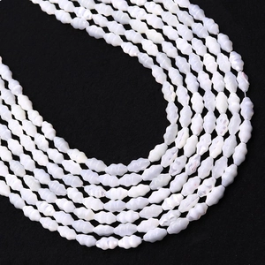Macro detail of natural mother of pearl shell beads with elegant wavy texture