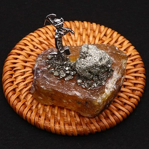 Macro shot of a creative miner figurine on amber crystal geode base with metallic ores
