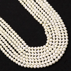 Faceted white round beads for DIY jewelry making with smooth glossy finish on dark background