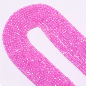 Macro detail of 2.5mm faceted hot pink zircon cube beads for DIY jewelry making