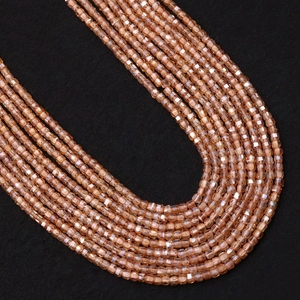 Macro shot of champagne zircon cube beads with faceted surfaces for DIY jewelry