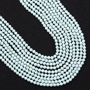 Macro shot of faceted mint green turquoise beads showing detailed multi-surface cut for jewelry
