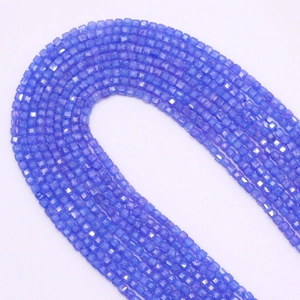Macro detail of 2.5mm faceted square zircon beads in violet blue for DIY jewelry making