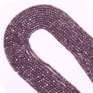 Detail of 2.5mm faceted purple natural stone beads with smooth cube cut and glossy finish