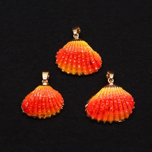 Three gradient orange scallop pendants with gold trim and radial shell texture
