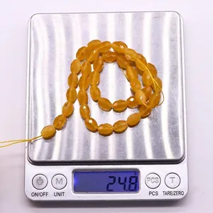 Detailed scale view of faceted orange cat eye stone beads weighing 24.8g for jewelry making
