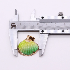 Macro shot showing 2.4cm width measurement of the gradient shell pendant with gold edges