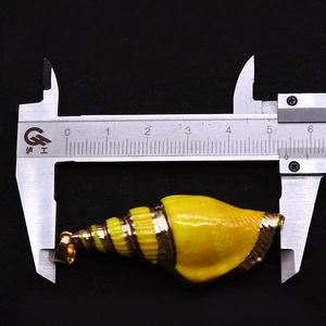 Macro shot measuring natural shell pendant with gold plating, length approximately 5.2cm