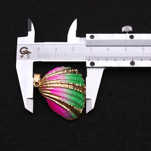 Detailed macro view showing a 28mm gradient pink and green shell pendant with gold plating