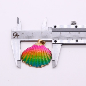 Detail of colorful gradient seashell pendant with gold edge measured by caliper