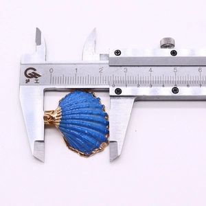 Blue seashell pendant with gold edge detail and 26mm width measurement on a caliper