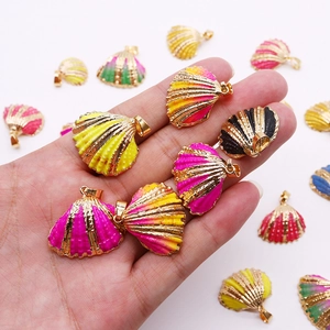 Handheld gold-plated natural seashell pendants in vibrant enamel colors with ring hooks