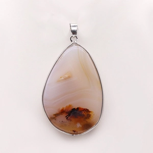 Macro shot of waterdrop teardrop agate pendant with silver electroplated metal edging