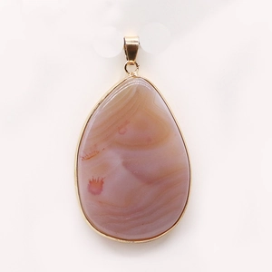 Detail showing natural striped agate teardrop pendant with gold-plated metal border