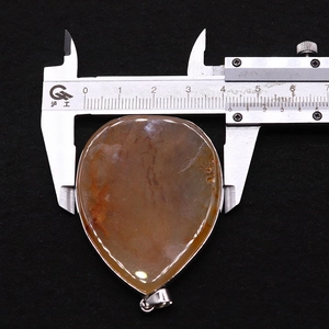 Macro view of teardrop agate pendant width measurement being 40mm with a caliper