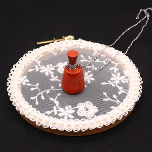 Red jasper gemstone perfume bottle pendant with silver chain and screw cap detail