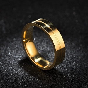 Macro shot of gold-tone ring featuring a polished finish and central groove detail