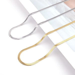 Sleek gold and silver snake bone blade necklaces for women in a minimalist wavy layout