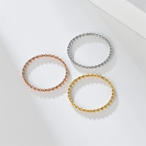 Detailed macro view of minimalist thin rope rings in silver, gold, and rose gold finishes