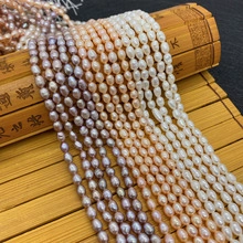 Close-up of white and purple natural freshwater oval pearls on a bamboo scroll background